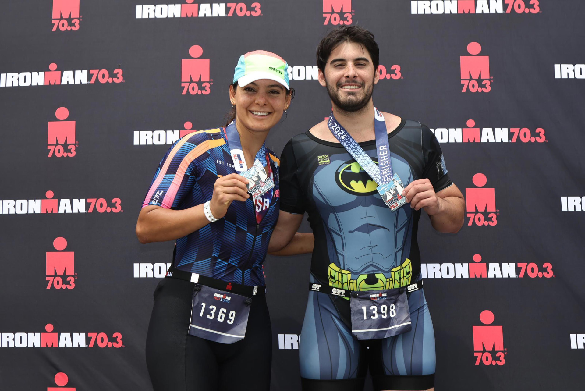 Janel and her brother at a race finish holding medals.